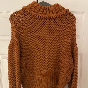 Super cute Free People sweater with a high neck. More of a brown/orange color.